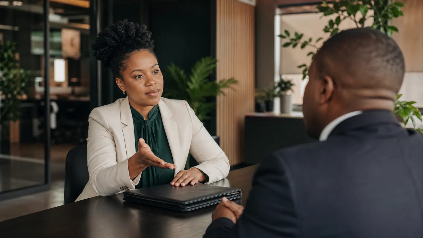 Candidate and interviewer having a calm professional conversation across a table