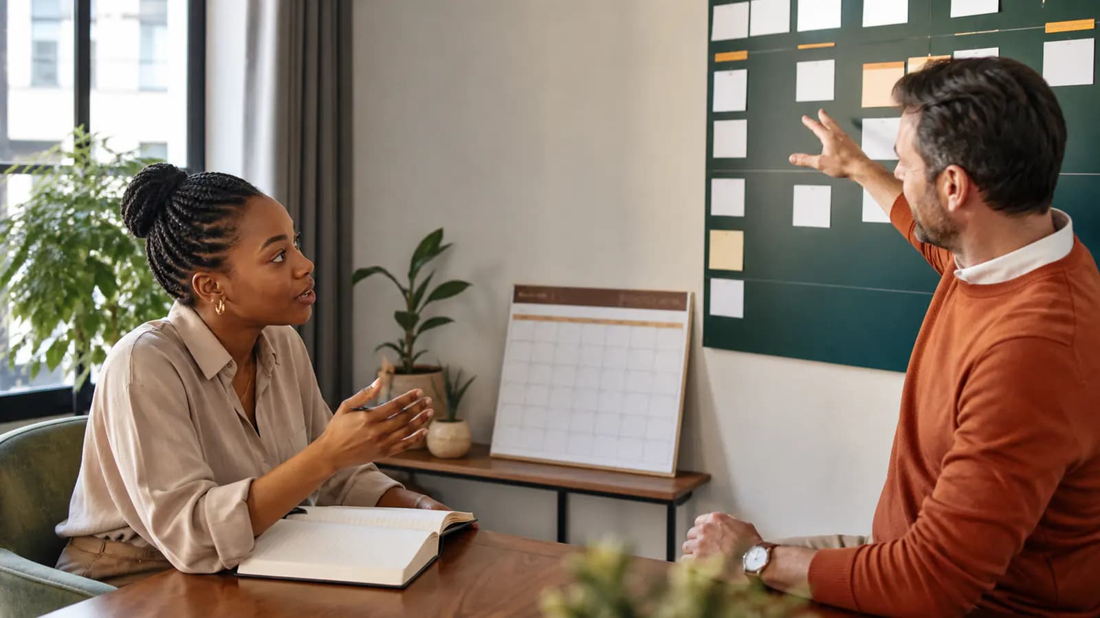 Candidate asking a question while a manager explains a board of blank task cards