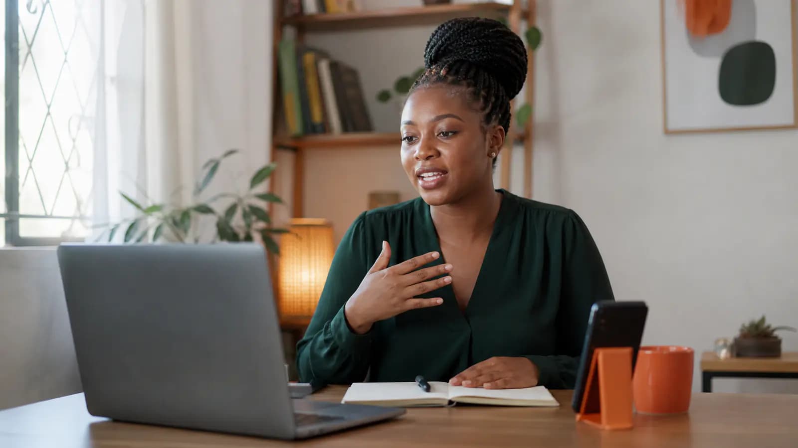 Professional rehearsing an introduction at a home desk with a laptop and phone timer
